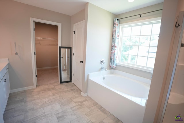 133 W River Cane Run, Perry, GA 31069 - bathroom featuring vanity, a bath, and a walk in closet