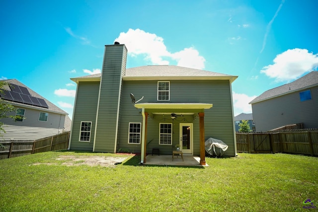 133 W River Cane Run, Perry, GA 31069 - back of property featuring a patio area, a chimney, a ceiling fan, and a fenced backyard