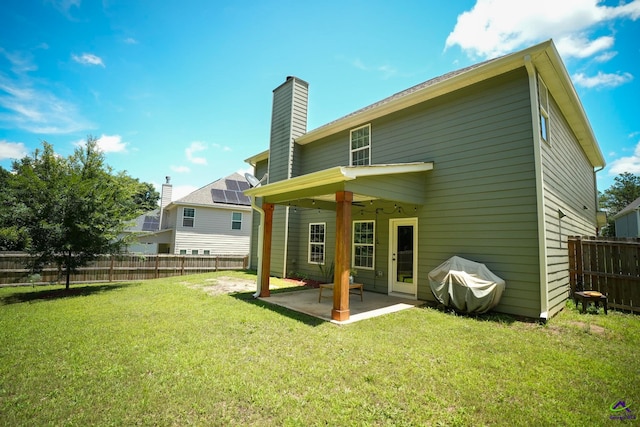 133 W River Cane Run, Perry, GA 31069 - rear view of property featuring a patio, a fenced backyard, and a chimney