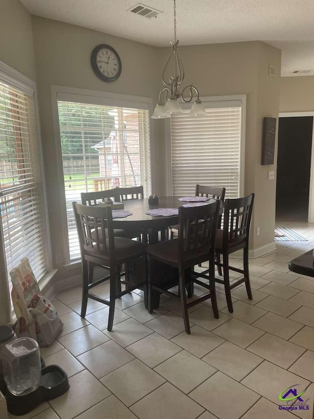 113 Ruzic Dr, Kathleen, GA 31047 - dining room with a chandelier, light tile patterned floors, and a textured ceiling
