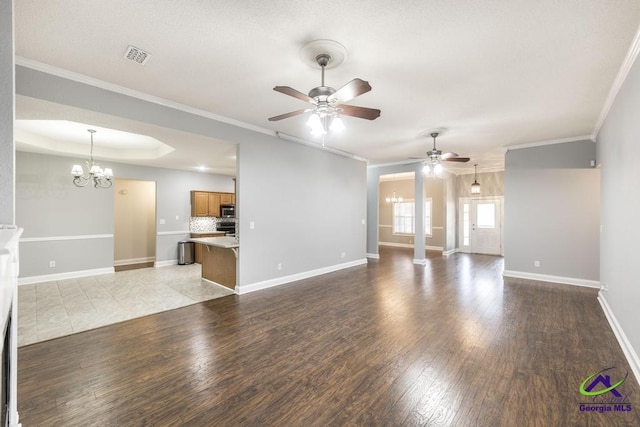 310 Woods Edge Way, Warner Robins, GA 31088 - unfurnished living room with a ceiling fan, a chandelier, wood finished floors, and crown molding