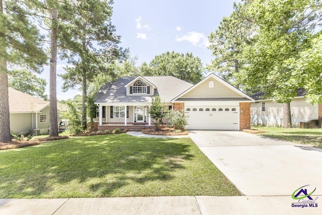310 Woods Edge Way, Warner Robins, GA 31088 - view of front facade featuring an attached garage, concrete driveway, brick siding, a porch, and a front yard