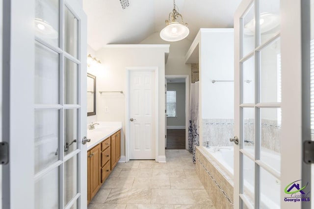 310 Woods Edge Way, Warner Robins, GA 31088 - bathroom featuring french doors, lofted ceiling, vanity, tiled tub, and a shower with shower curtain