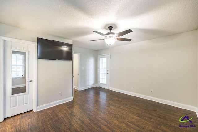 310 Woods Edge Way, Warner Robins, GA 31088 - unfurnished living room featuring dark wood-type flooring, ceiling fan, and a textured ceiling