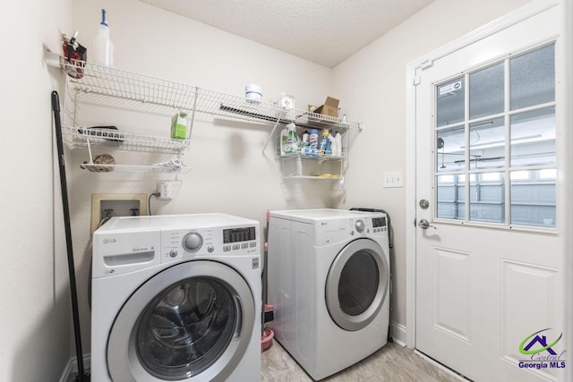 310 Woods Edge Way, Warner Robins, GA 31088 - laundry room featuring independent washer and dryer, light marble finish floors, and a textured ceiling
