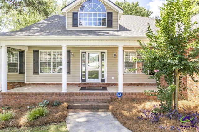 310 Woods Edge Way, Warner Robins, GA 31088 - view of front facade featuring covered porch, roof with shingles, and brick siding
