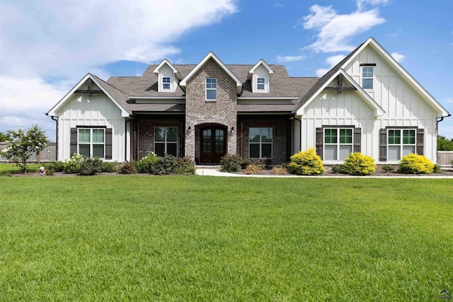 162 Talton Rd, Kathleen, GA 31047 - view of front of property with board and batten siding, a front lawn, brick siding, and a shingled roof