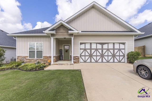 103 Cascades Ct, Bonaire, GA 31005 - craftsman-style home featuring board and batten siding, driveway, a front lawn, and a garage
