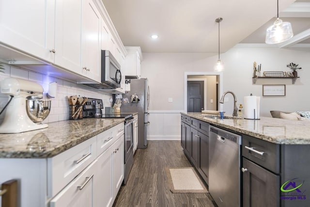 103 Cascades Ct, Bonaire, GA 31005 - kitchen featuring appliances with stainless steel finishes, dark wood-type flooring, white cabinets, a center island with sink, and light stone counters