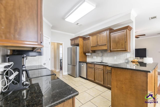 112 Verandah Ct, Bonaire, GA 31005 - kitchen featuring stainless steel appliances, decorative backsplash, dark stone countertops, light tile patterned flooring, and ornamental molding