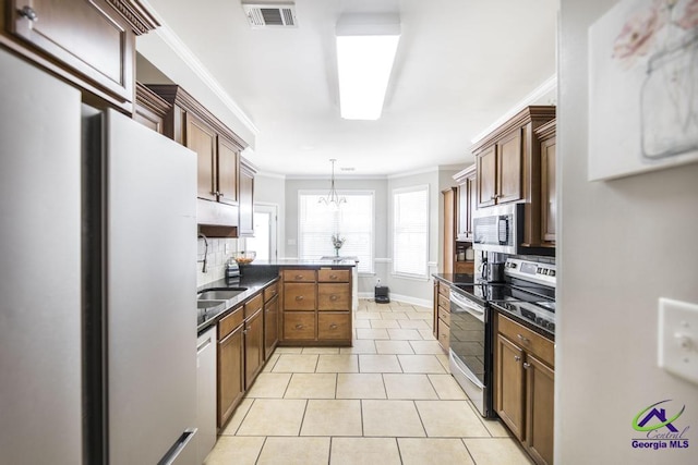 112 Verandah Ct, Bonaire, GA 31005 - kitchen with stainless steel appliances, ornamental molding, decorative backsplash, light tile patterned floors, and decorative light fixtures
