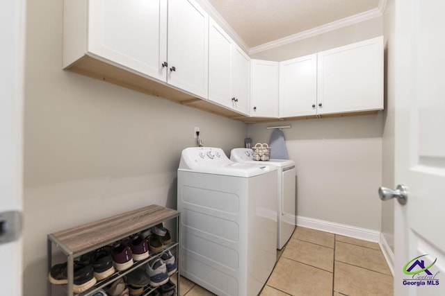 112 Verandah Ct, Bonaire, GA 31005 - laundry room featuring separate washer and dryer, cabinet space, crown molding, and light tile patterned flooring