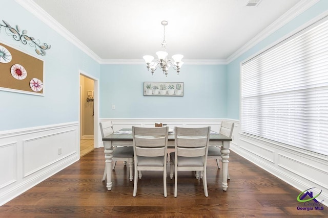 112 Verandah Ct, Bonaire, GA 31005 - dining area with a chandelier, crown molding, a wainscoted wall, wood finished floors, and a decorative wall