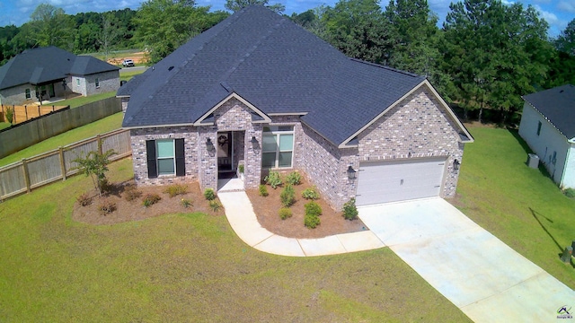 109 Raspberry Trl, Perry, GA 31069 - view of front of house featuring brick siding, a garage, concrete driveway, and roof with shingles