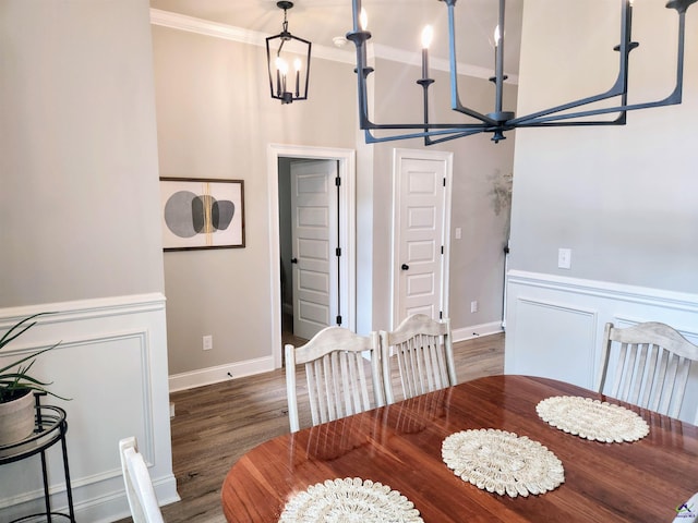 109 Raspberry Trl, Perry, GA 31069 - dining room with a chandelier, ornamental molding, wood finished floors, a wainscoted wall, and a decorative wall