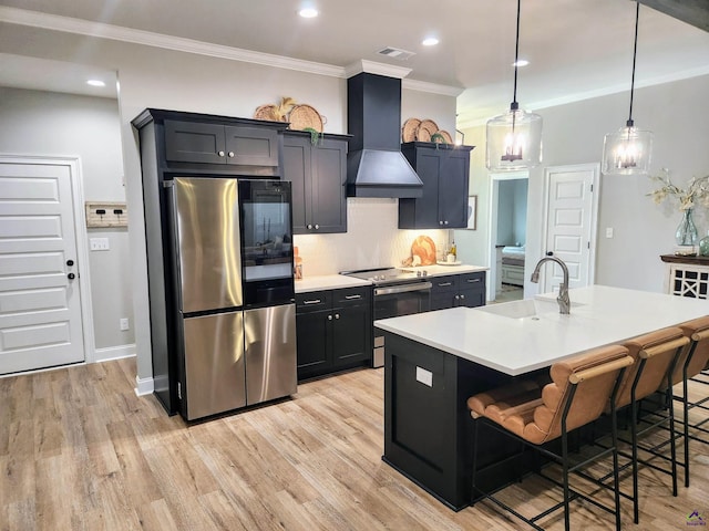 109 Raspberry Trl, Perry, GA 31069 - kitchen with appliances with stainless steel finishes, custom exhaust hood, ornamental molding, light countertops, and light wood-style flooring