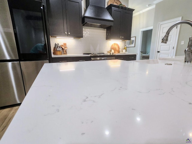 109 Raspberry Trl, Perry, GA 31069 - kitchen with premium range hood, smart refrigerator, decorative backsplash, ornamental molding, and light stone counters