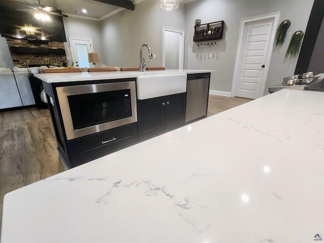 109 Raspberry Trl, Perry, GA 31069 - kitchen with stainless steel appliances, wood finished floors, crown molding, open floor plan, and light stone counters