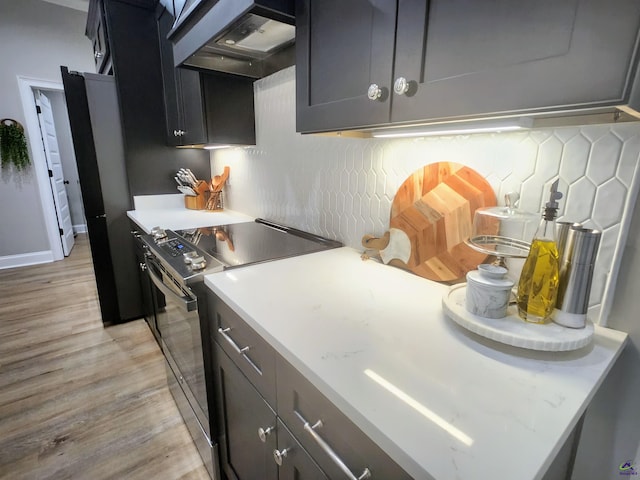 109 Raspberry Trl, Perry, GA 31069 - kitchen with electric range, wall chimney exhaust hood, light wood finished floors, and decorative backsplash