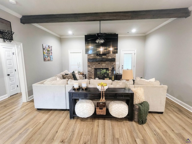 109 Raspberry Trl, Perry, GA 31069 - living area with beam ceiling, wood finished floors, ornamental molding, a ceiling fan, and a brick fireplace