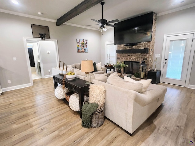 109 Raspberry Trl, Perry, GA 31069 - living area featuring light wood-style floors, a ceiling fan, a brick fireplace, crown molding, and beamed ceiling
