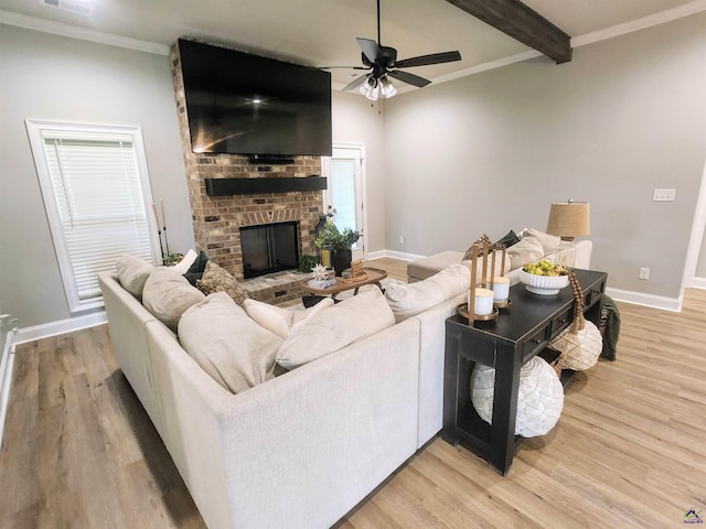 109 Raspberry Trl, Perry, GA 31069 - living room with light wood-style floors, a fireplace, ceiling fan, beam ceiling, and crown molding