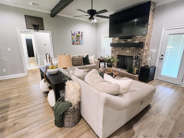 109 Raspberry Trl, Perry, GA 31069 - living room featuring light wood-style floors, ceiling fan, a brick fireplace, ornamental molding, and beam ceiling