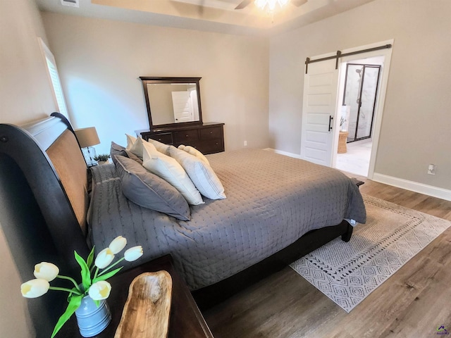 109 Raspberry Trl, Perry, GA 31069 - bedroom with a barn door and wood finished floors