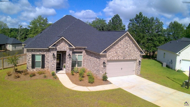 109 Raspberry Trl, Perry, GA 31069 - view of front of home with brick siding, an attached garage, driveway, and a shingled roof