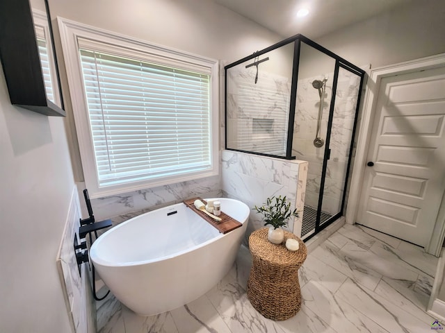109 Raspberry Trl, Perry, GA 31069 - bathroom featuring marble look tile flooring, a freestanding bath, and a shower stall
