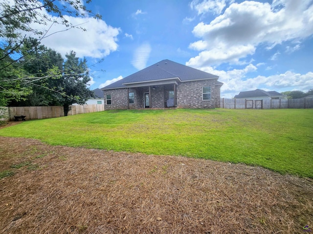 109 Raspberry Trl, Perry, GA 31069 - back of house featuring a fenced backyard and brick siding