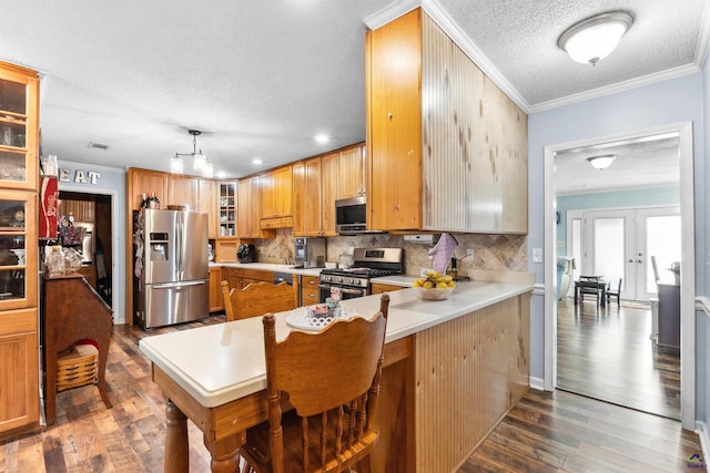 113 Chestnut Rd, Warner Robins, GA 31088 - kitchen featuring appliances with stainless steel finishes, a textured ceiling, crown molding, backsplash, and dark wood-type flooring