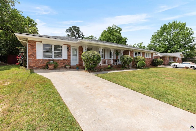 113 Chestnut Rd, Warner Robins, GA 31088 - single story home featuring a porch, brick siding, concrete driveway, and a front yard