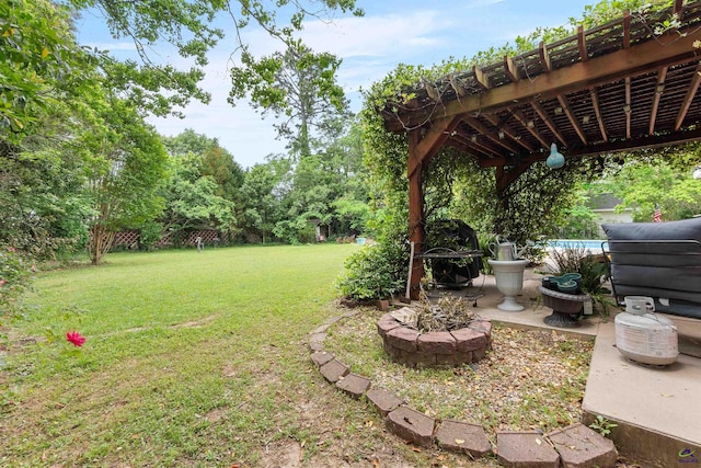 113 Chestnut Rd, Warner Robins, GA 31088 - view of green lawn with an outdoor fire pit, a pergola, a pool, and a patio