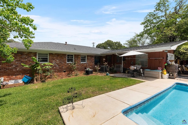 113 Chestnut Rd, Warner Robins, GA 31088 - rear view of property featuring a patio, a lawn, an outdoor pool, brick siding, and roof with shingles