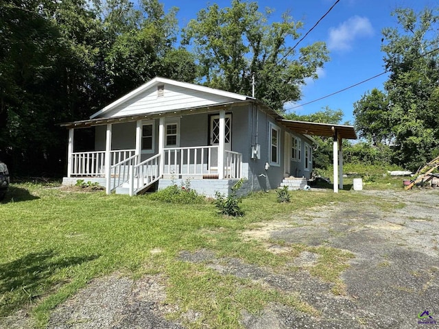 2017 Lowe St, Macon, GA 31204 - view of front of house with a porch, a front yard, and concrete block siding
