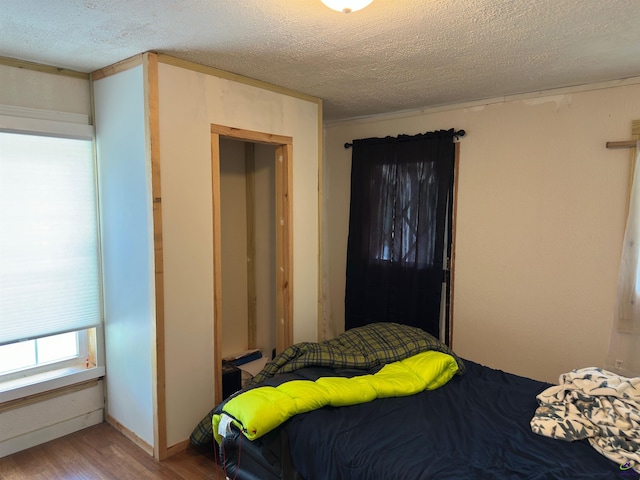 2017 Lowe St, Macon, GA 31204 - bedroom with wood finished floors and a textured ceiling
