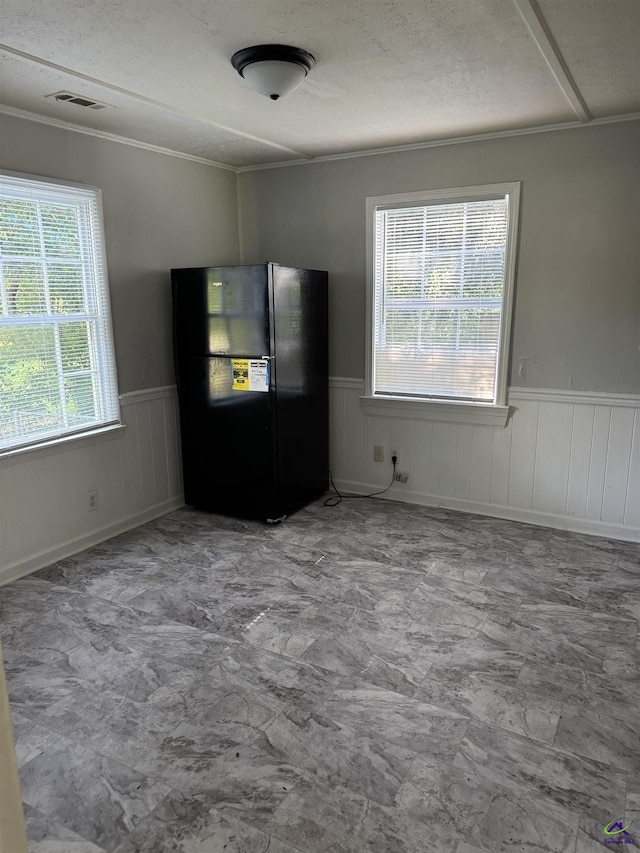 314 Arnold Blvd, Warner Robins, GA 31093 - spare room featuring wainscoting, ornamental molding, and a textured ceiling