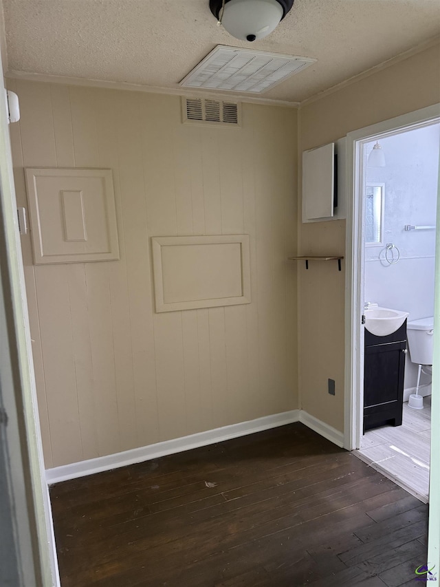314 Arnold Blvd, Warner Robins, GA 31093 - empty room featuring dark wood-style flooring, a textured ceiling, and crown molding