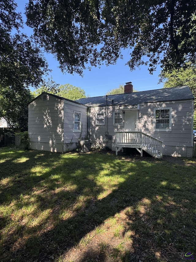 314 Arnold Blvd, Warner Robins, GA 31093 - back of house featuring a yard and a chimney