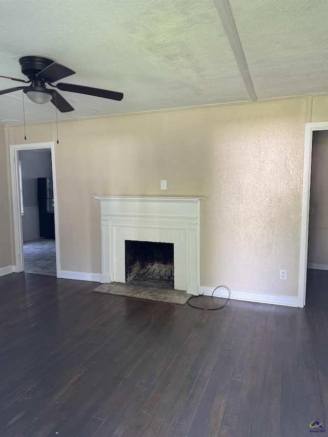 314 Arnold Blvd, Warner Robins, GA 31093 - unfurnished living room with ceiling fan, a fireplace, wood finished floors, and a textured ceiling