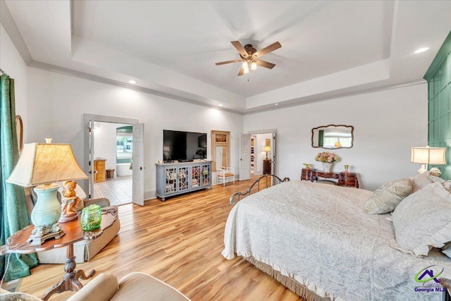 117 Pine Bough Trl, Perry, GA 31609 - bedroom featuring a raised ceiling, light wood-type flooring, recessed lighting, and a ceiling fan