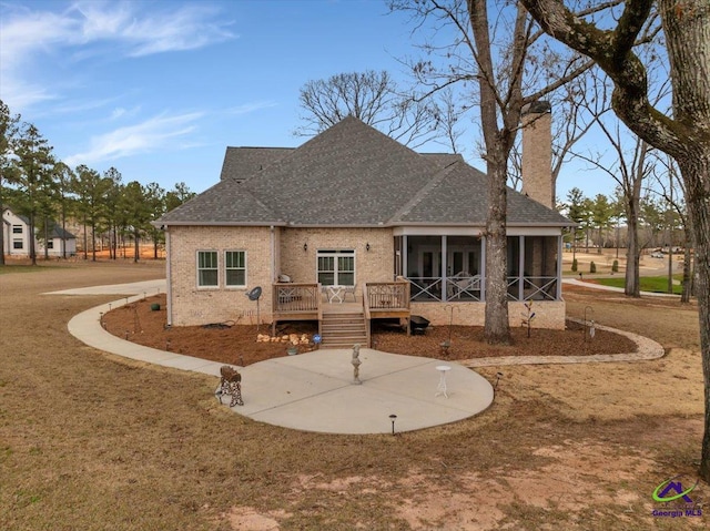 117 Pine Bough Trl, Perry, GA 31609 - back of house with a chimney, a shingled roof, a sunroom, and a wooden deck