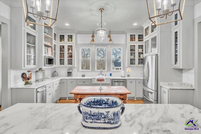 117 Pine Bough Trl, Perry, GA 31609 - kitchen featuring stainless steel appliances, light stone counters, a chandelier, backsplash, and recessed lighting