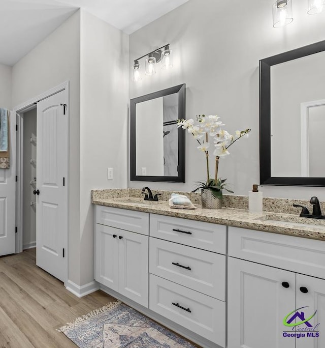 3055 Cellar Ln, Perry, GA 31069 - bathroom featuring double vanity and wood finished floors