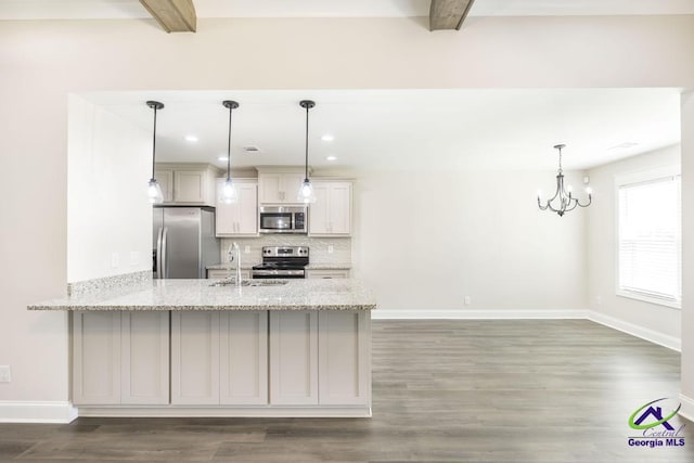 102 Sugar Creek Trl, Perry, GA 31069 - kitchen featuring stainless steel appliances, beam ceiling, a peninsula, decorative backsplash, and wood finished floors