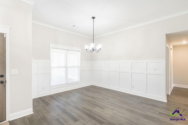 102 Sugar Creek Trl, Perry, GA 31069 - empty room featuring a decorative wall, crown molding, dark wood-type flooring, a chandelier, and a wainscoted wall