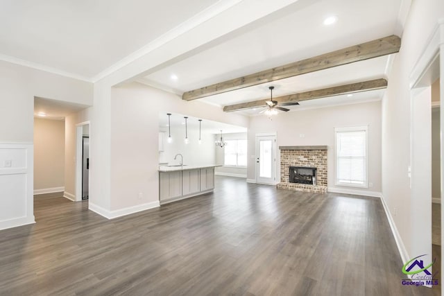 102 Sugar Creek Trl, Perry, GA 31069 - unfurnished living room featuring a ceiling fan, dark wood-style floors, a fireplace, recessed lighting, and beam ceiling