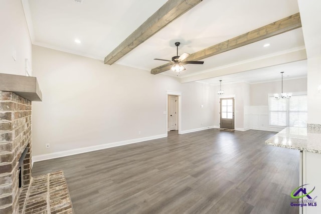 102 Sugar Creek Trl, Perry, GA 31069 - unfurnished living room with a fireplace, a ceiling fan, beamed ceiling, dark wood-type flooring, and a chandelier