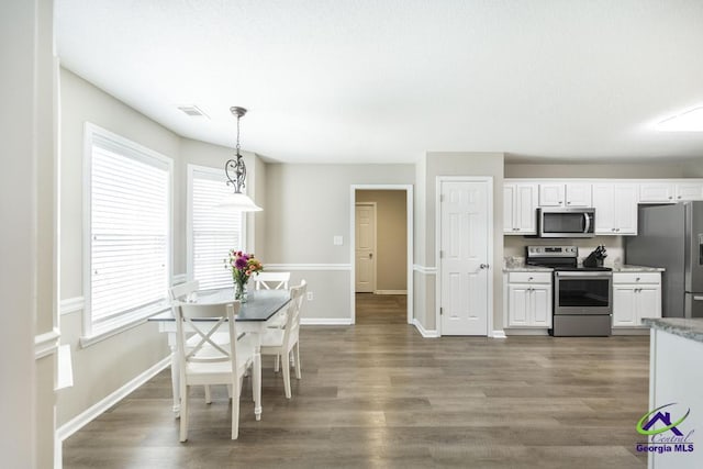 546 Grove Ln, Kathleen, GA 31047 - kitchen with appliances with stainless steel finishes, white cabinetry, and dark wood-style flooring
